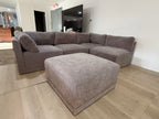 Five-piece modular sectional with matching ottoman in the showroom