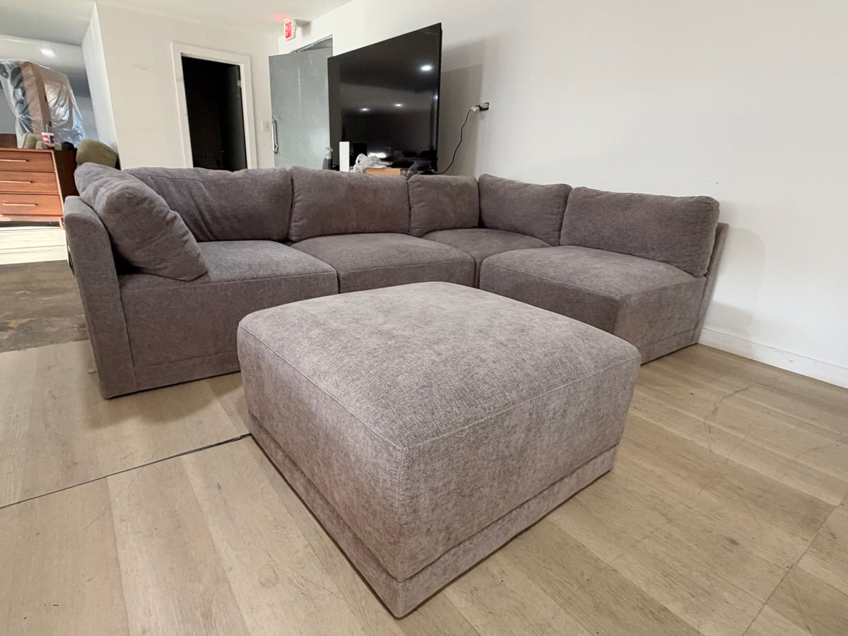 Five-piece modular sectional with matching ottoman in the showroom