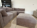 Five-piece modular sectional with matching ottoman in the showroom