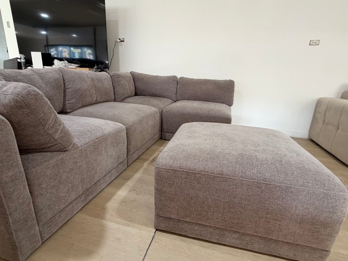 Five-piece modular sectional with matching ottoman in the showroom