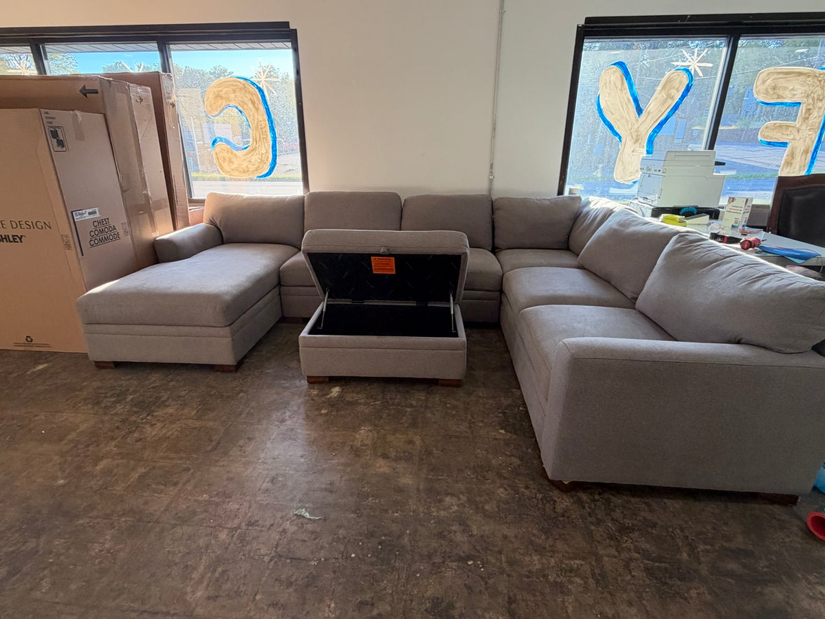 Gray sectional with matching storage ottoman shown open